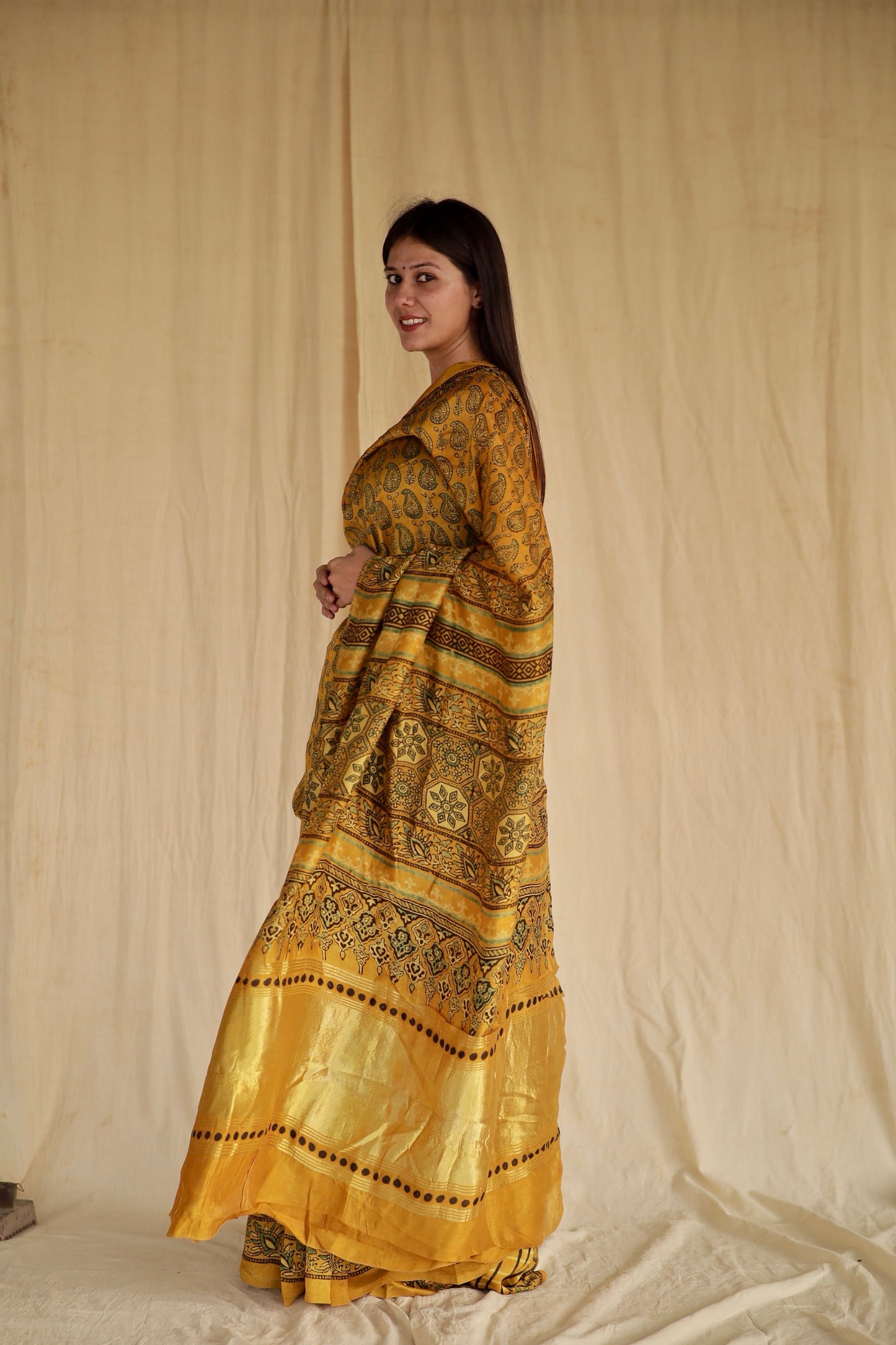 Handcrafted olive gold Chanderi silk saree adorned with traditional Ajrakh patterns and delicate texture
