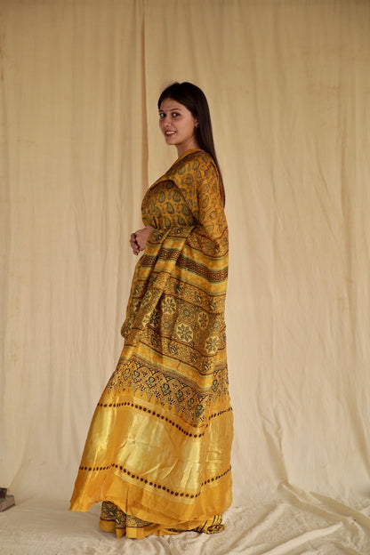 Handcrafted olive gold Chanderi silk saree adorned with traditional Ajrakh patterns and delicate texture