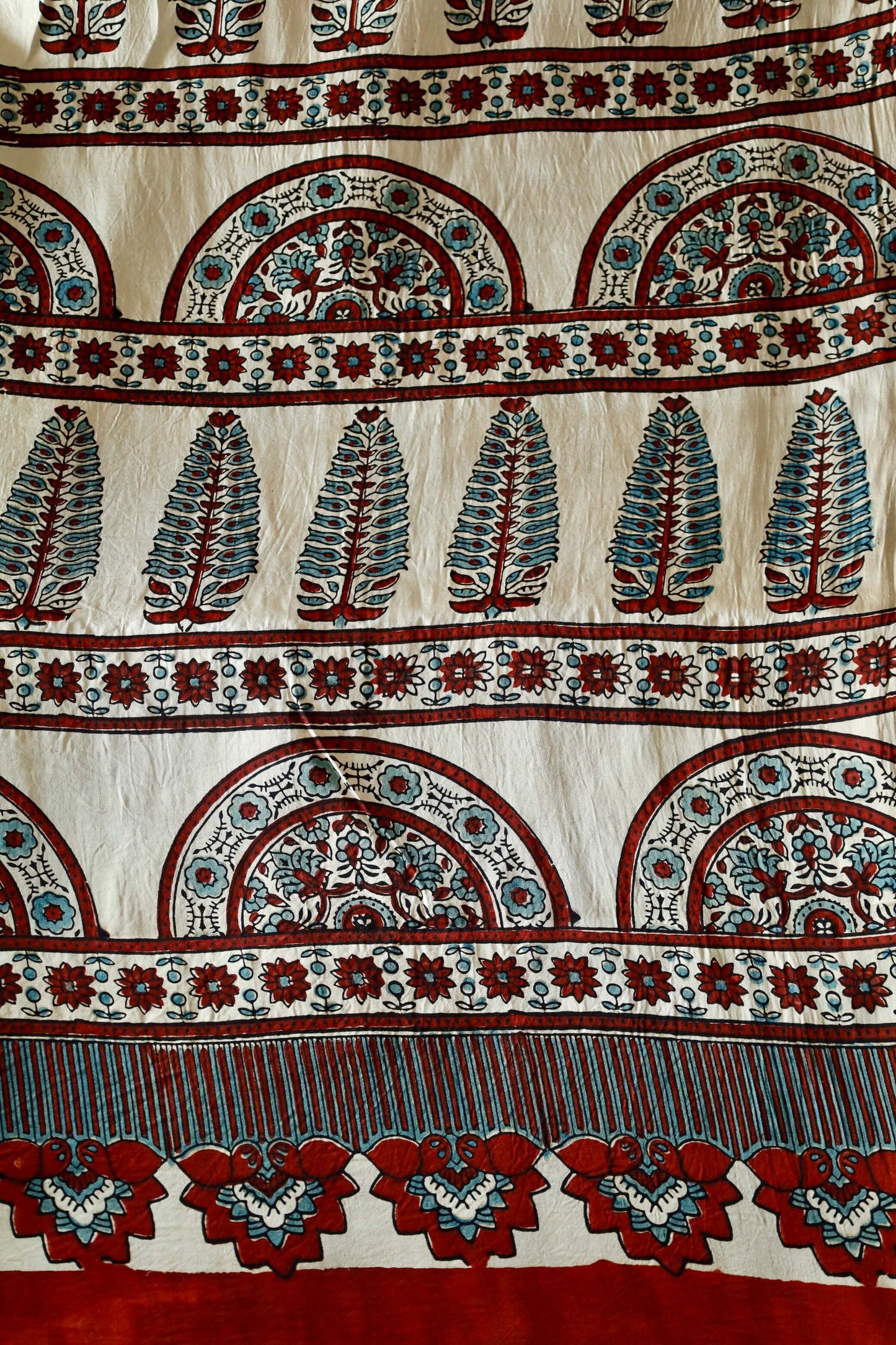 Premium pearl white Ajrakh saree showcasing detailed artisan block printing on modal silk