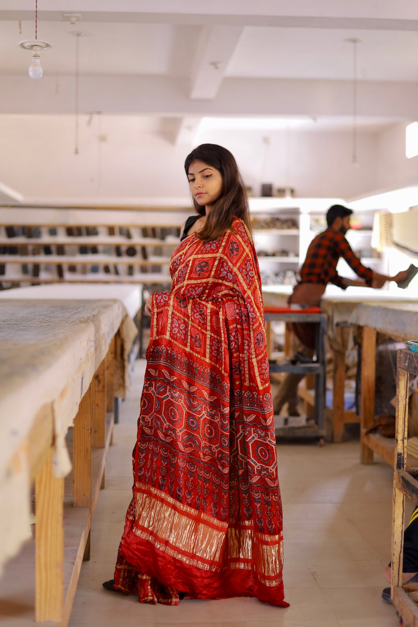 Handcrafted red Gharchola modal silk saree adorned with intricate Ajrakh patterns and heritage-inspired detailing