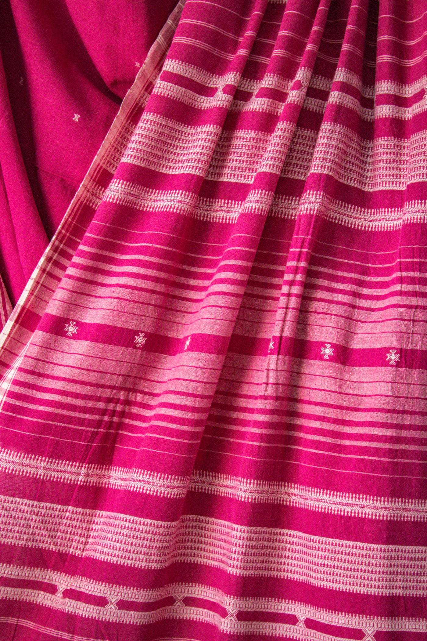 Handcrafted rose Kala Cotton saree adorned with authentic Bhujodi weaving and heritage-inspired motifs