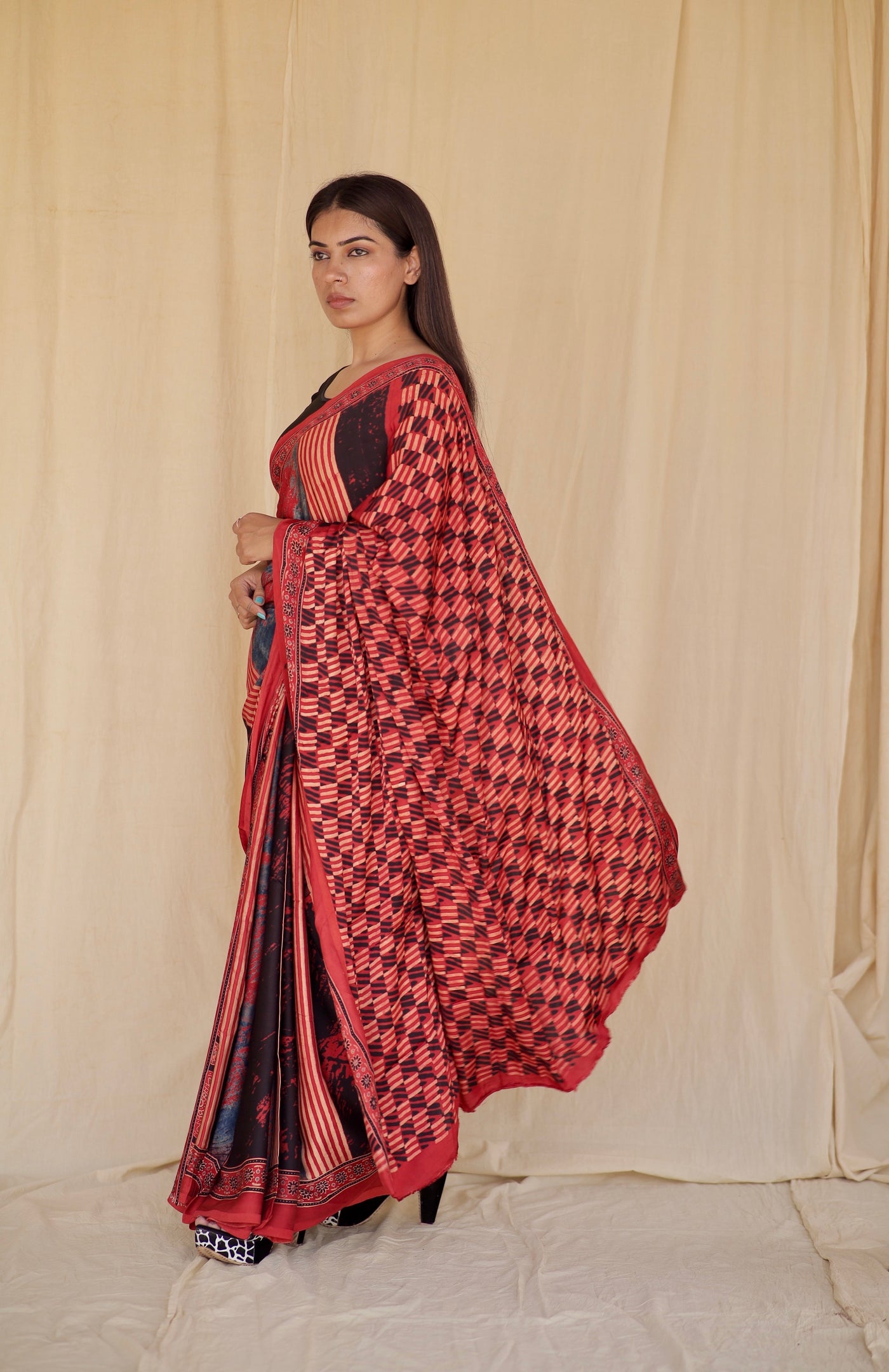 Handcrafted scarlet and black modal silk saree adorned with traditional Ajrakh patterns and refined detailing