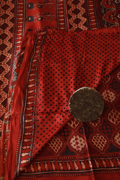 Elegant scarlet red Ajrakh saree in modal silk showcasing detailed artisan block printing