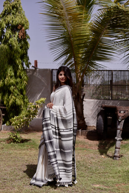 Handcrafted slate Kala Cotton saree adorned with authentic Bhujodi weaving and heritage-inspired motifs