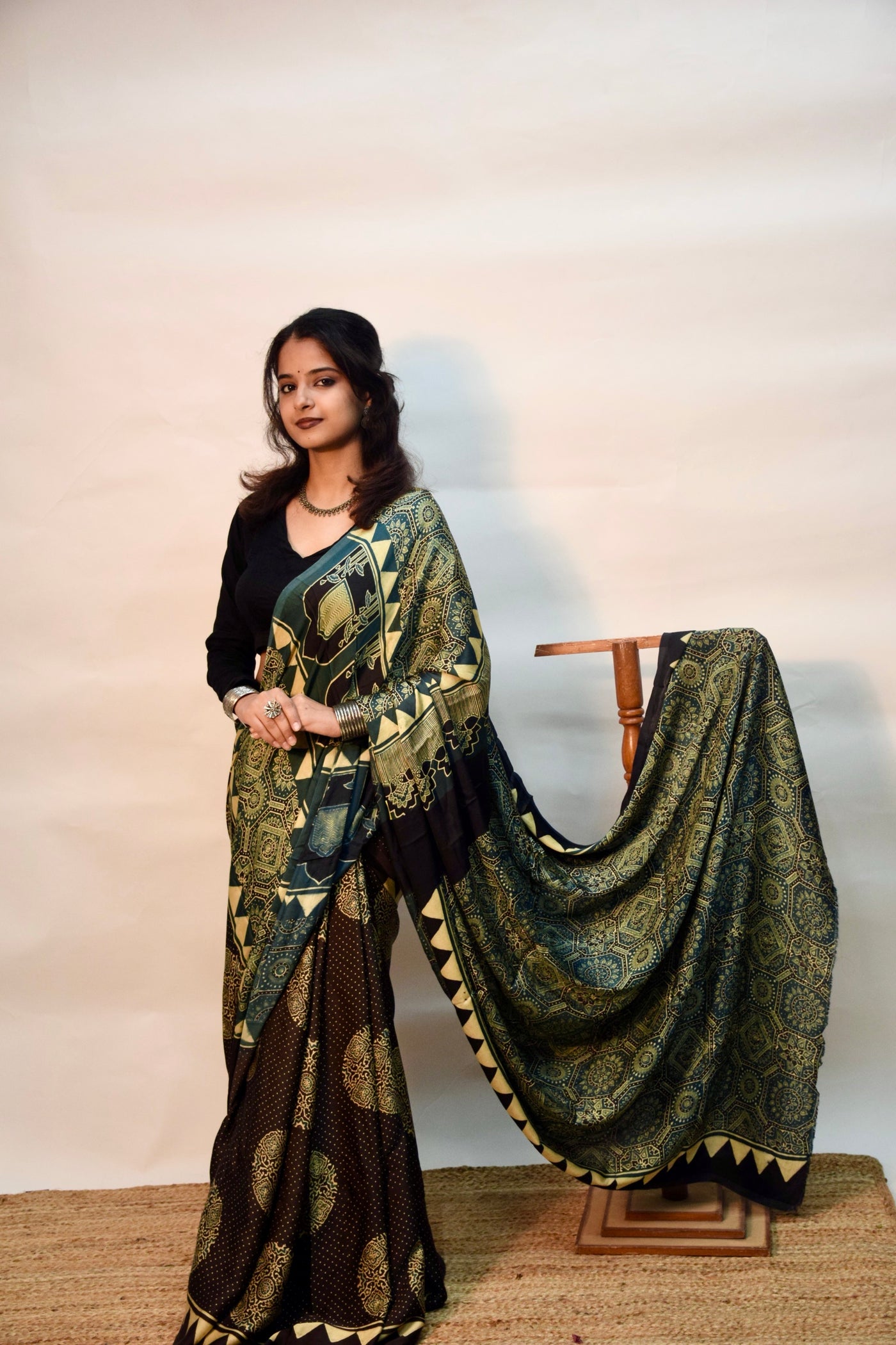 Handcrafted teal blue modal silk saree adorned with traditional Ajrakh patterns and fine detailing