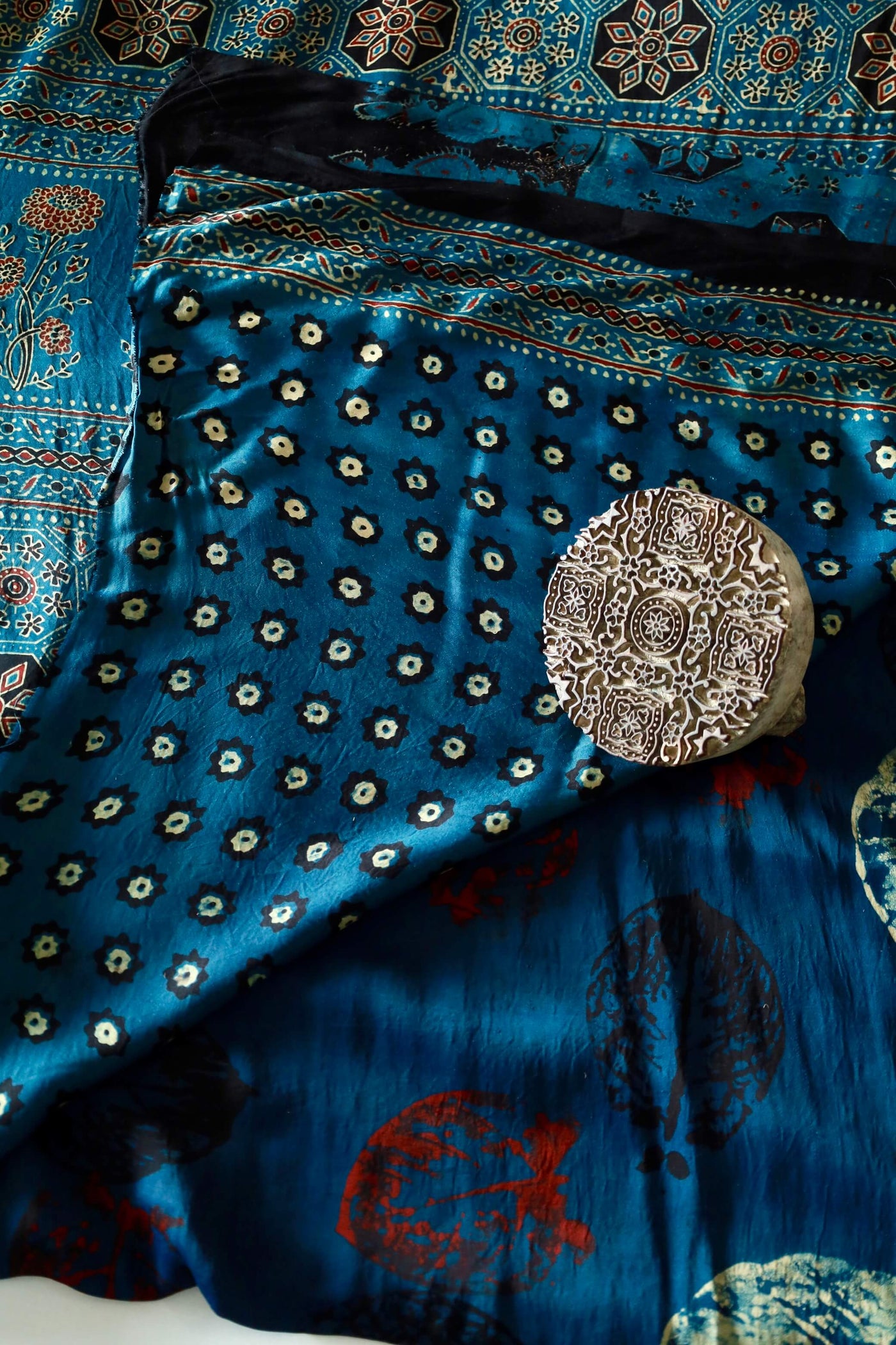 Handcrafted turquoise blue modal silk saree adorned with traditional Ajrakh patterns and artisanal detailing