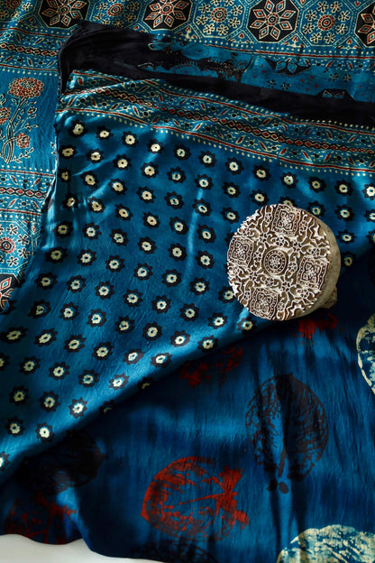 Handcrafted turquoise blue modal silk saree adorned with traditional Ajrakh patterns and artisanal detailing