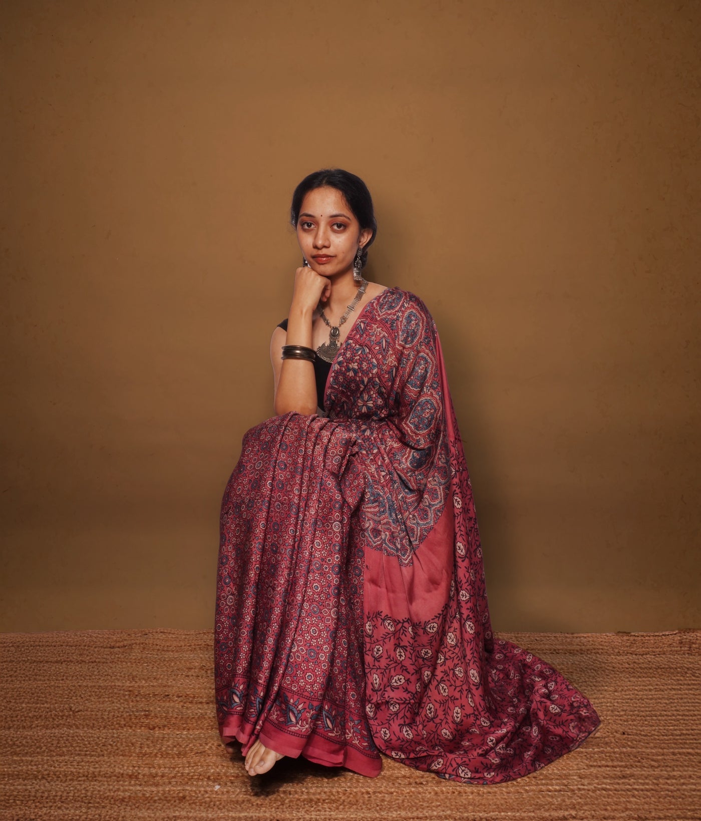 Handcrafted wine pink modal silk saree adorned with traditional Ajrakh patterns and refined detailing