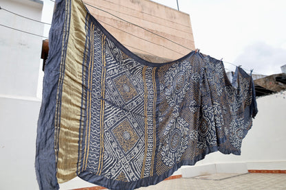 Indigo Rai Bandhani silk saree featuring intricate tie-dye patterns and an elegant zari pallu