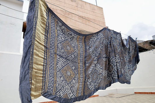 Indigo Rai Bandhani silk saree featuring intricate tie-dye patterns and an elegant zari pallu