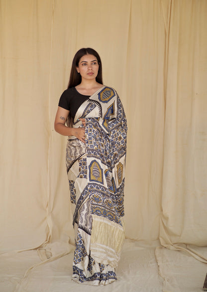Ivory white Ajrakh modal silk saree featuring intricate hand block printed motifs and a graceful drape