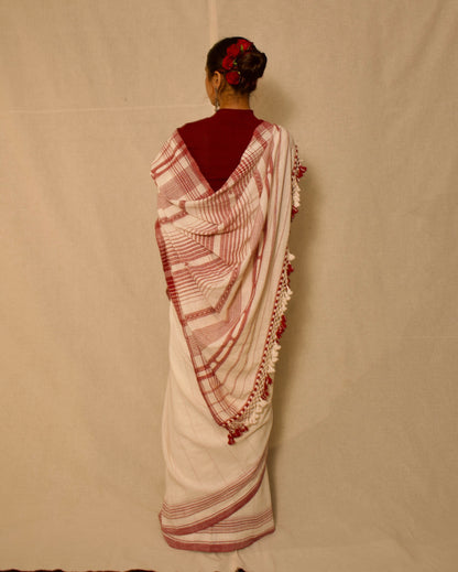 Premium ivory Kala Cotton saree showcasing traditional Bhujodi textile artistry and timeless appeal. Traditional ivory Bhujodi Kala Cotton saree with rich handwoven textures and graceful drape