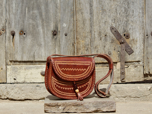 Leather bag adorned with intricate thread work on premium handcrafted leather