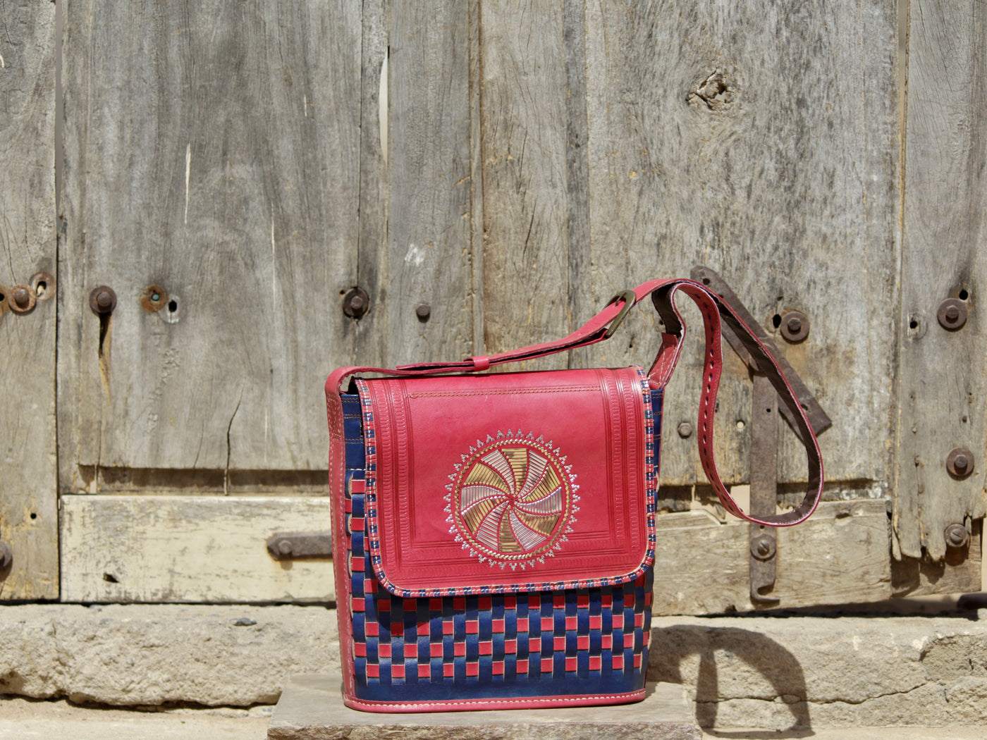 Leather bag adorned with intricate zari work on premium handcrafted leather