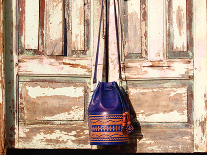 Leather potli bag adorned with intricate thread work on premium handcrafted leather