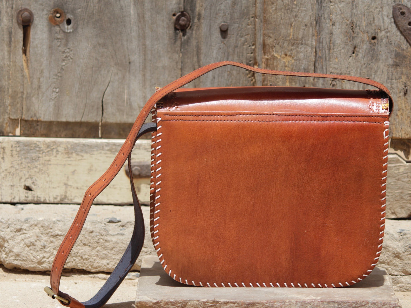 Artisan-crafted leather bag featuring traditional hand stitching and durable construction