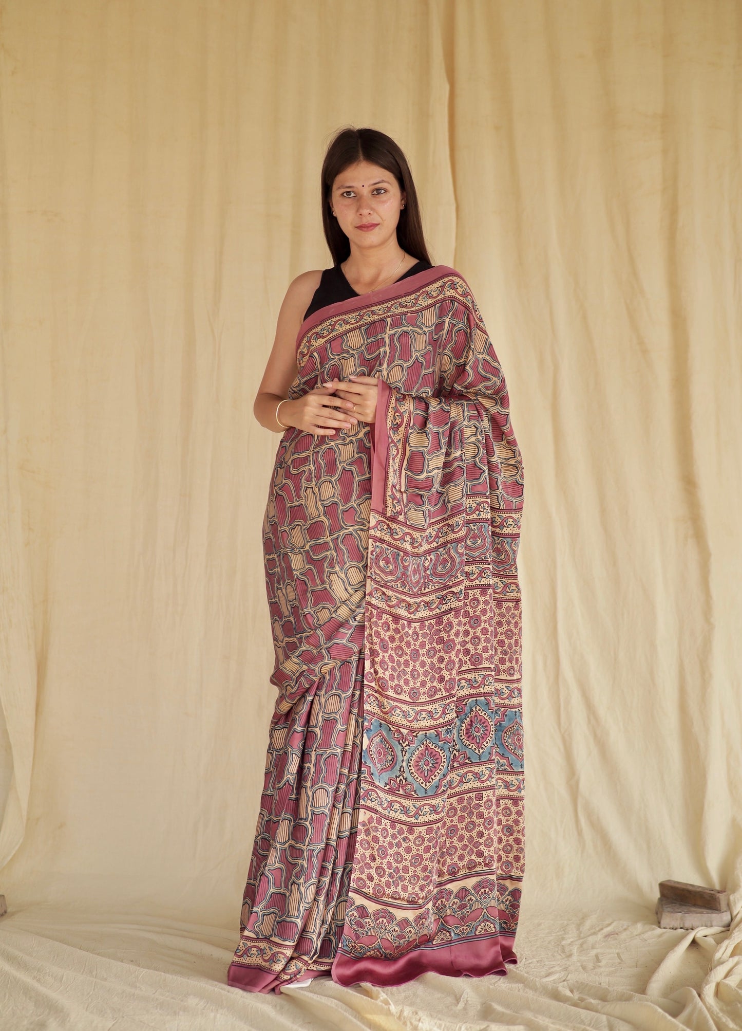 Mauve pink Ajrakh modal silk saree featuring intricate hand block printed motifs and a graceful drape