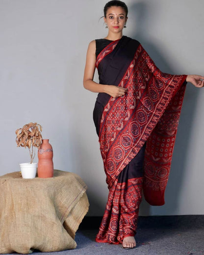 Midnight black and red Ajrakh modal silk saree featuring intricate hand block printed motifs and a graceful drape