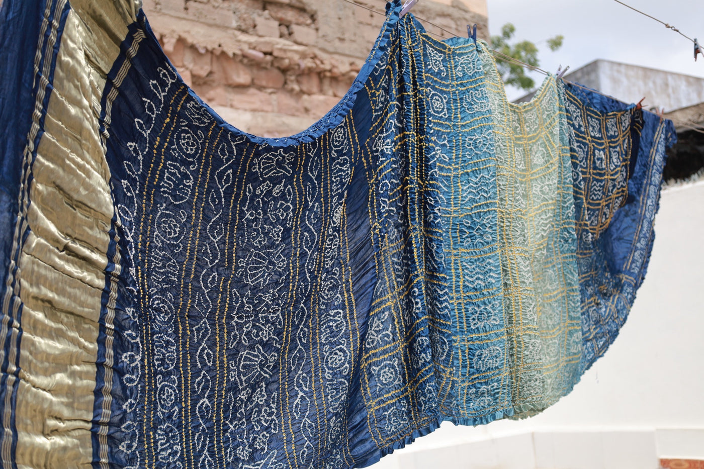 Midnight blue Rai Bandhani silk saree featuring intricate tie-dye patterns and an elegant zari pallu