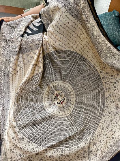 Premium midnight and grey handpainted saree reflecting the cultural richness and storytelling tradition of Mata Ni Pachedi art. Traditional midnight and grey Mata Ni Pachedi saree with vibrant handpainted motifs and graceful artisanal craftsmanship