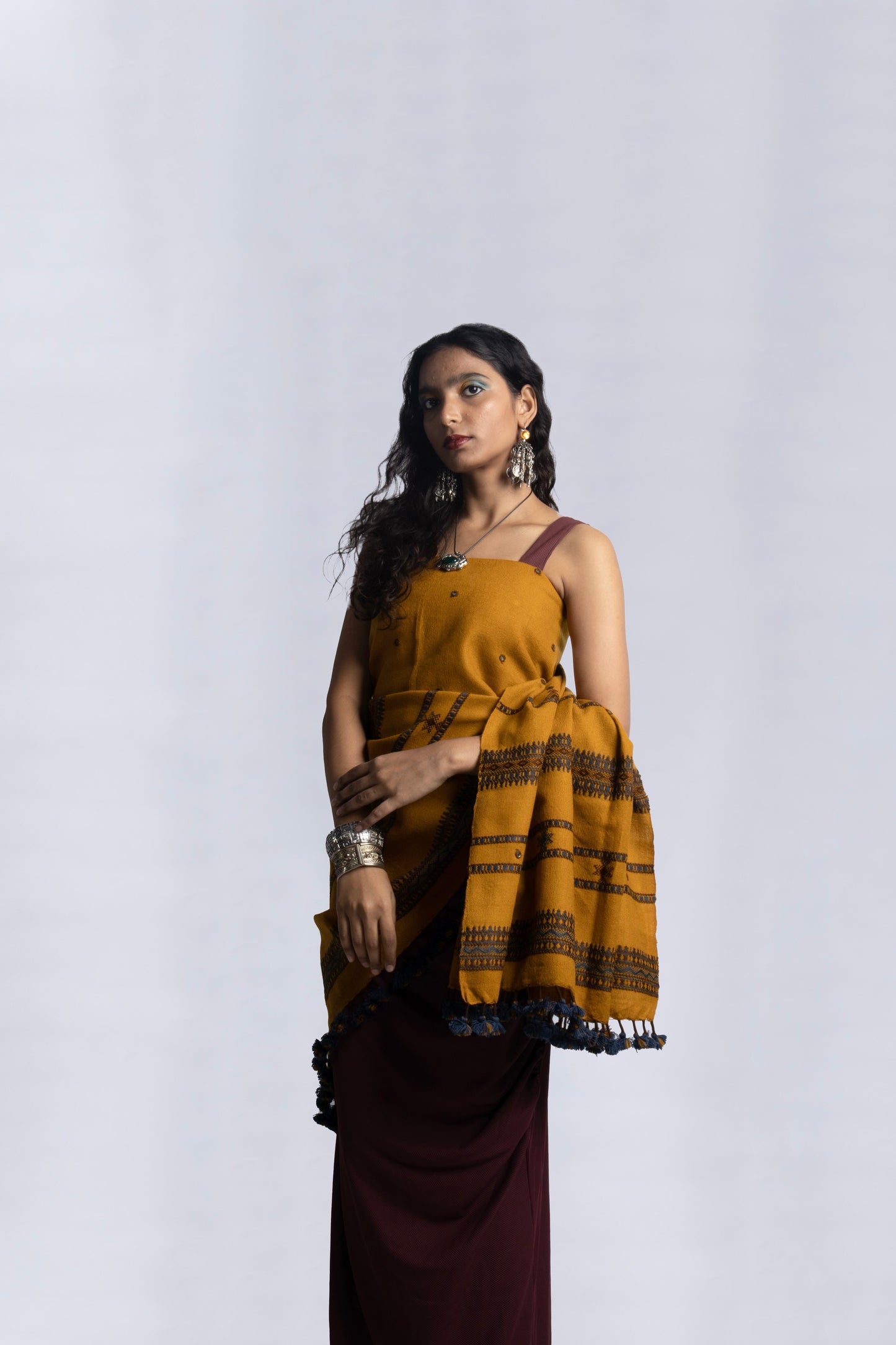 Mustard handwoven woolen shawl featuring a warm golden hue and skilled artisan craftsmanship