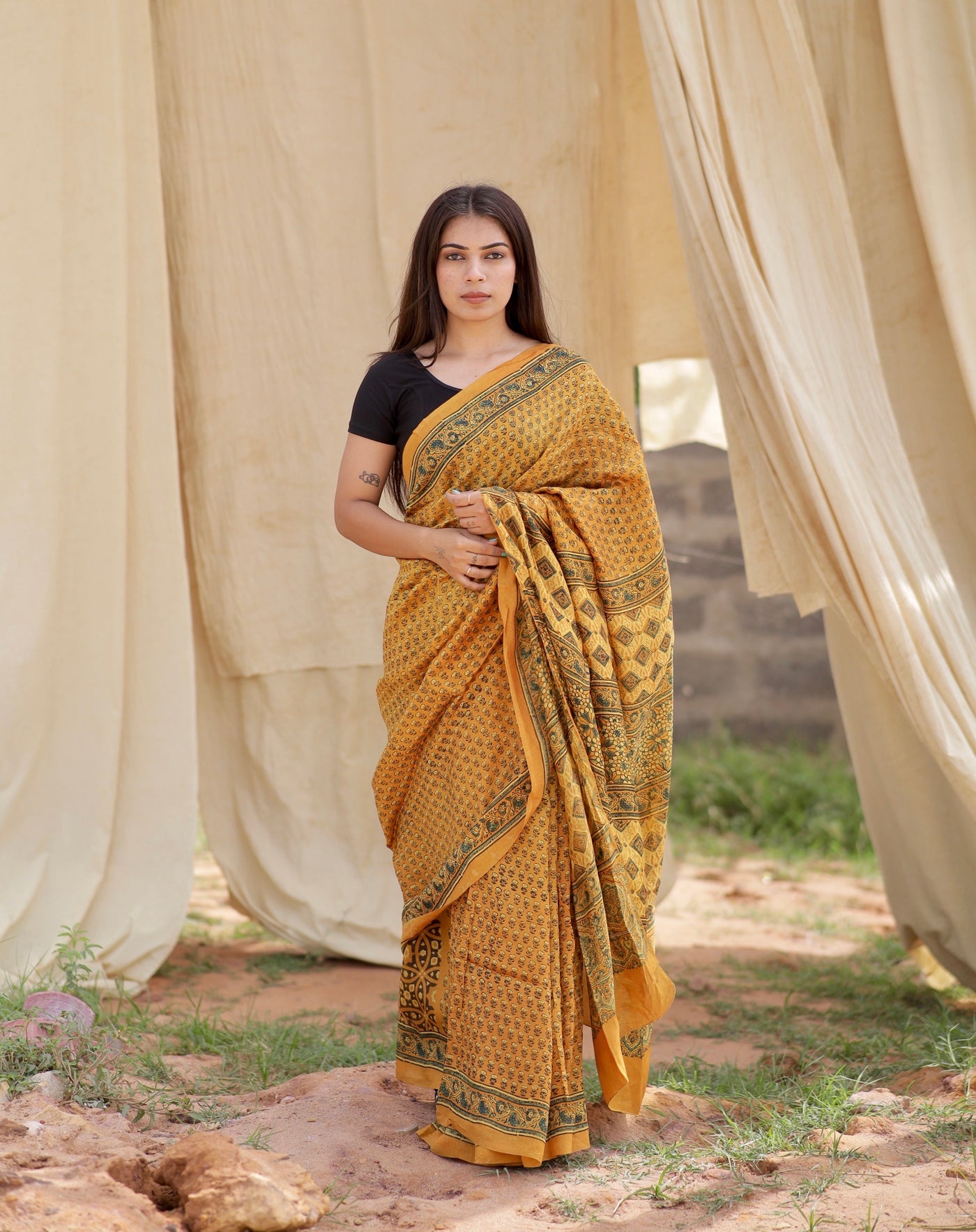 Mustard yellow Ajrakh Chanderi silk saree featuring intricate hand block printed motifs and a graceful drape