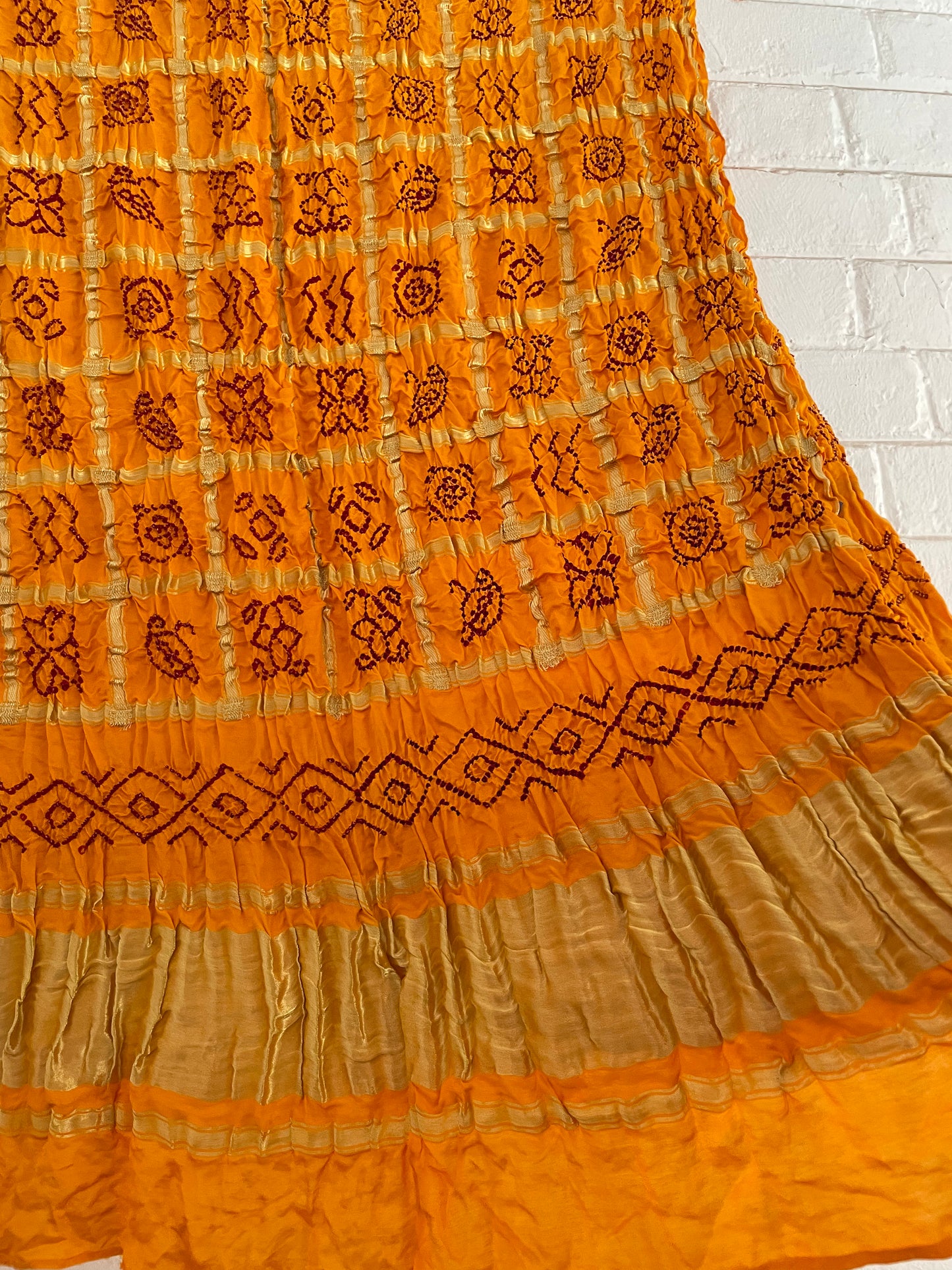 Handcrafted mustard yellow Gharchola dupatta featuring authentic Bandhani patterns and zari detailing