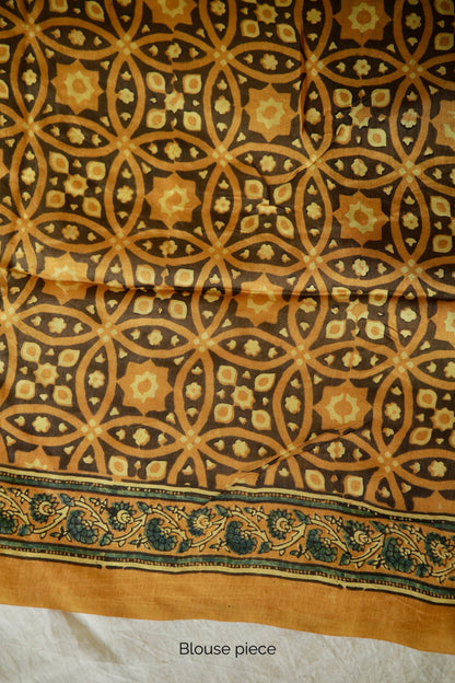 Premium mustard yellow Chanderi silk saree with heritage-inspired Ajrakh designs and subtle sheen. Traditional mustard yellow Ajrakh printed Chanderi silk saree crafted by skilled artisans with refined detailing