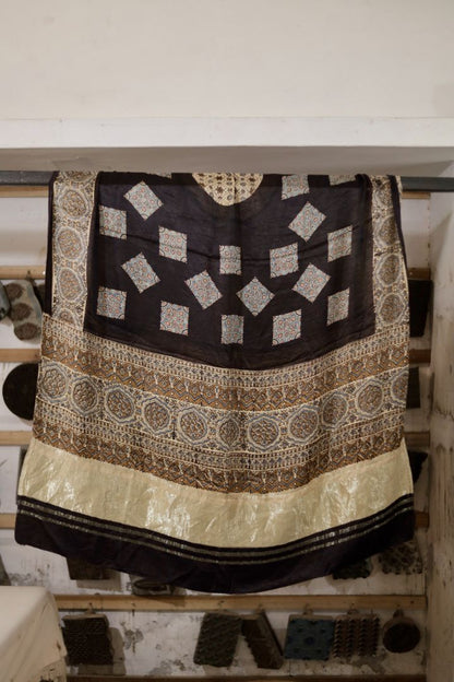 Natural black Ajrakh modal silk dupatta with Lagdi Patta featuring intricate block printed motifs and elegant drape