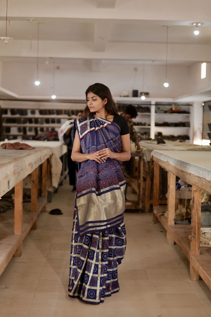 Handcrafted navy blue Gharchola modal silk saree adorned with intricate Ajrakh patterns and heritage-inspired detailing
