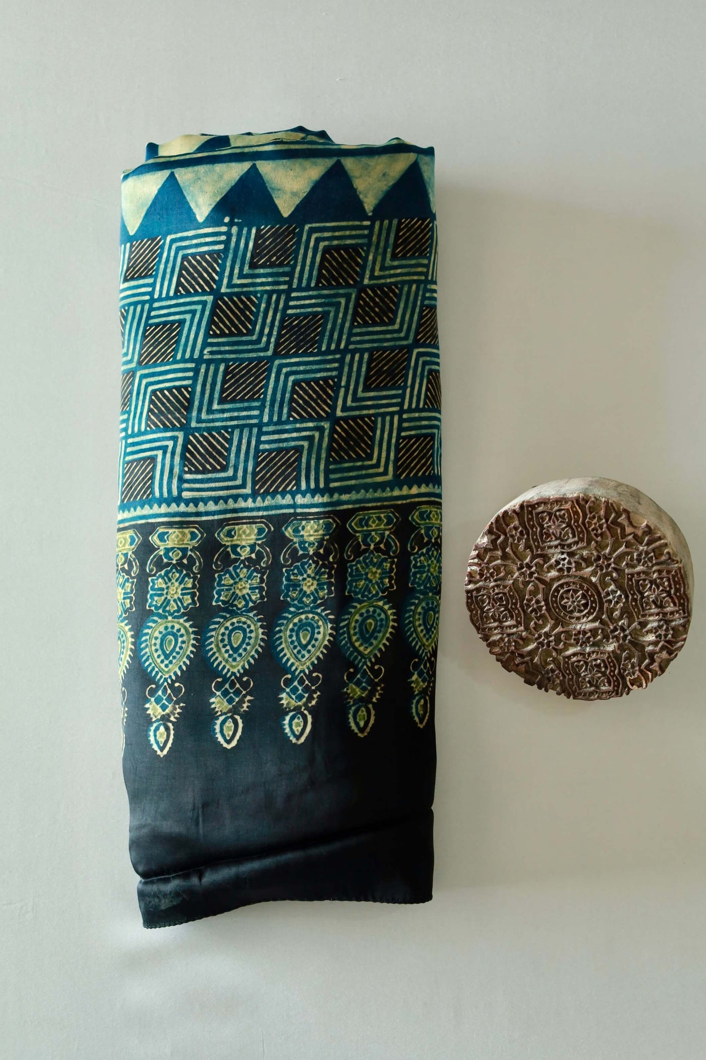 Navy teal Ajrakh modal silk saree featuring intricate hand block printed motifs and a graceful drape