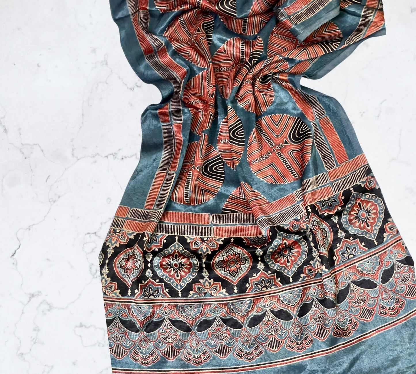 Ocean blue Ajrakh Mashru silk stole featuring intricate hand block printed motifs and elegant drape
