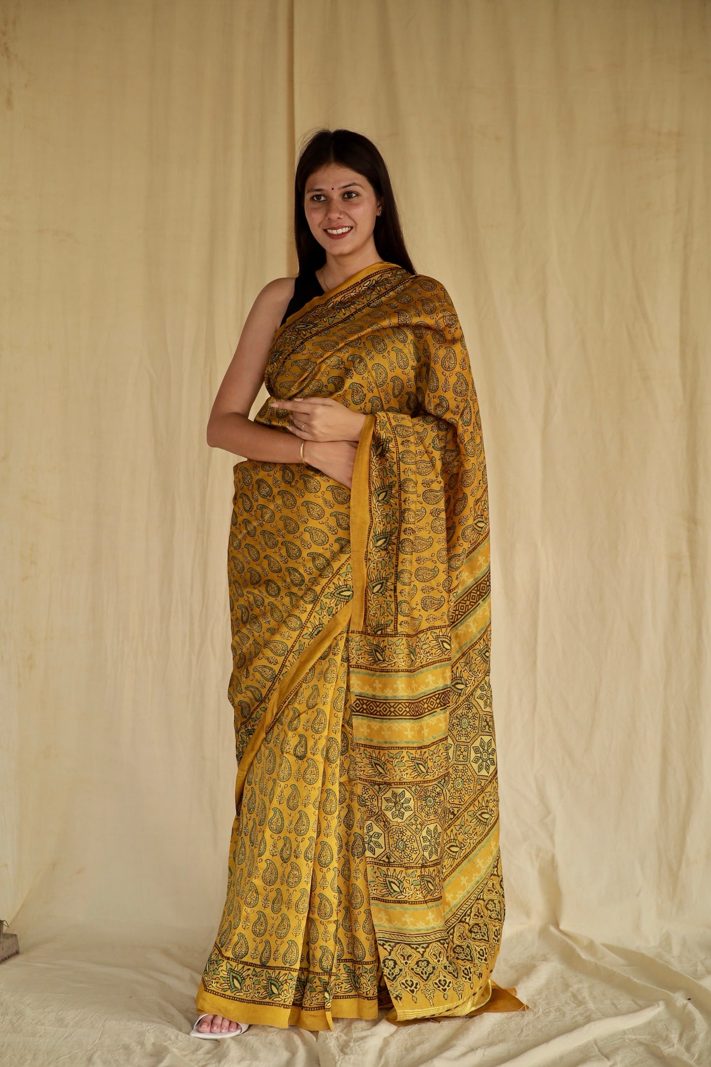 Olive gold Ajrakh Chanderi silk saree featuring intricate hand block printed motifs and a graceful drape