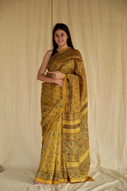 Olive gold Ajrakh Chanderi silk saree featuring intricate hand block printed motifs and a graceful drape