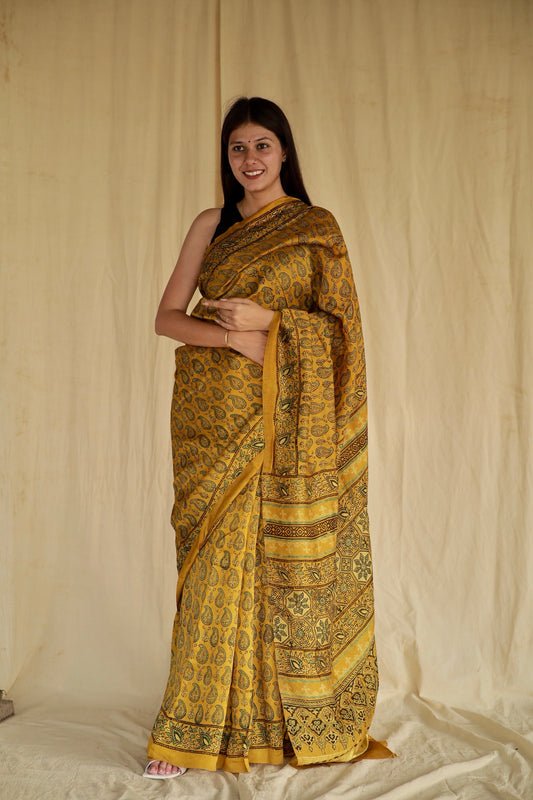 Olive gold Ajrakh Chanderi silk saree featuring intricate hand block printed motifs and a graceful drape