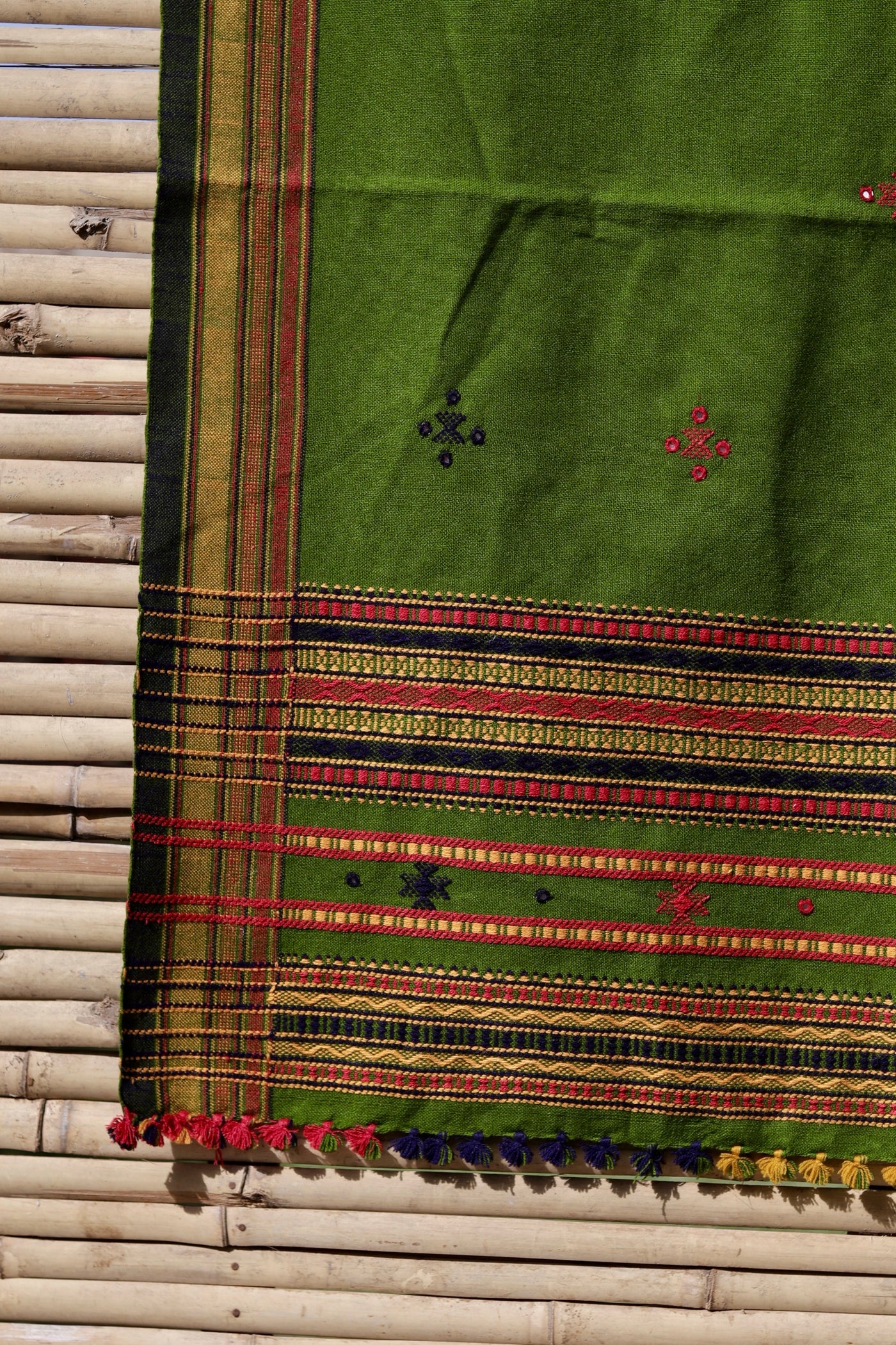 Olive green handwoven woolen shawl featuring an earthy hue and exceptional artisan craftsmanship