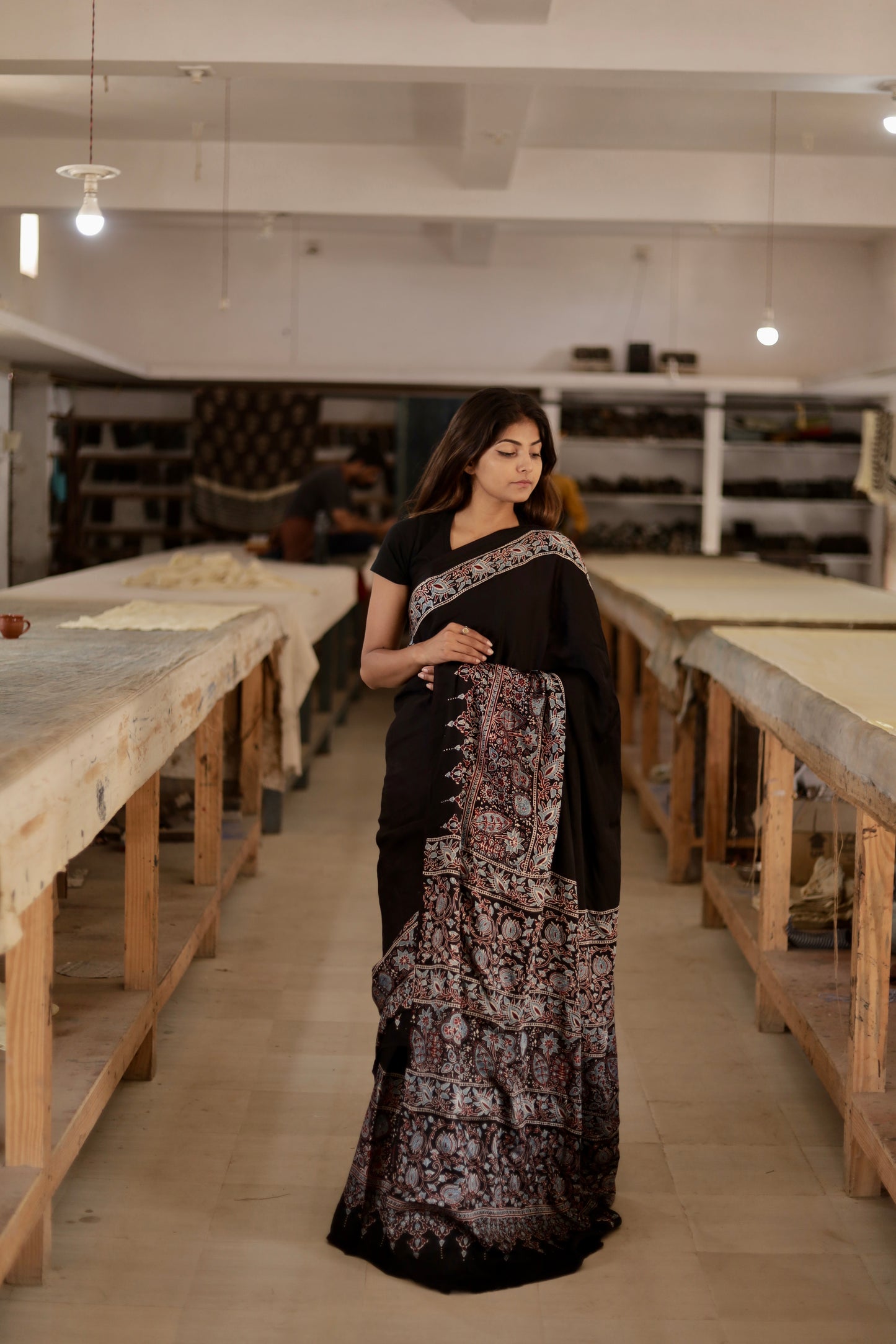 Plain black Ajrakh modal silk saree featuring subtle handcrafted detailing and an elegant drape