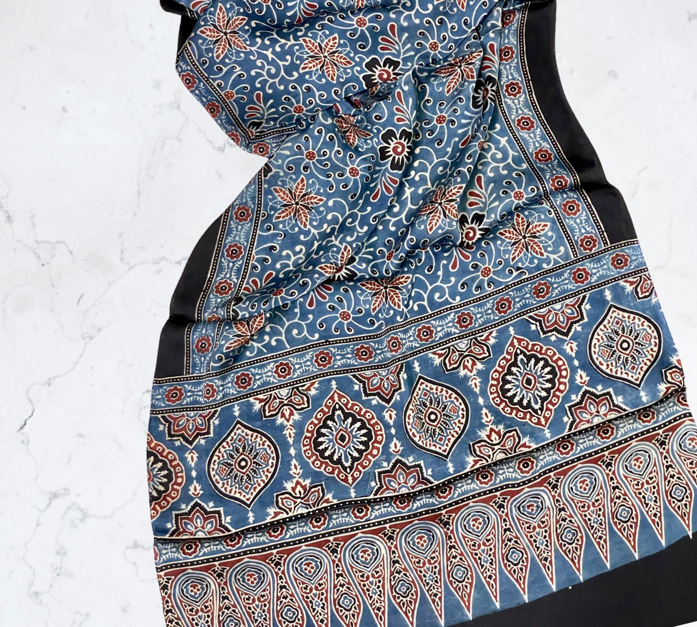 Powder blue Ajrakh modal silk stole featuring intricate hand block printed motifs and elegant drape