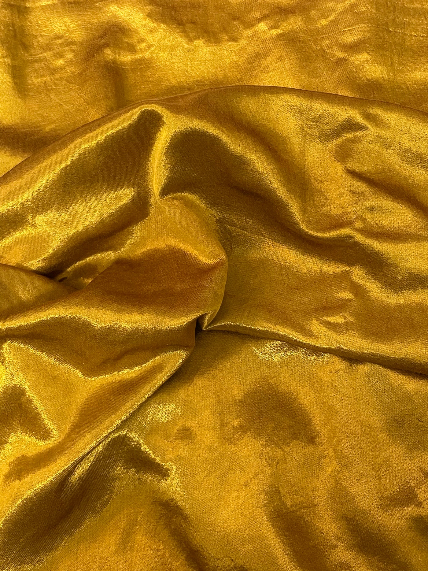 Premium antique gold ethnic dress material adorned with decorative mirror accents