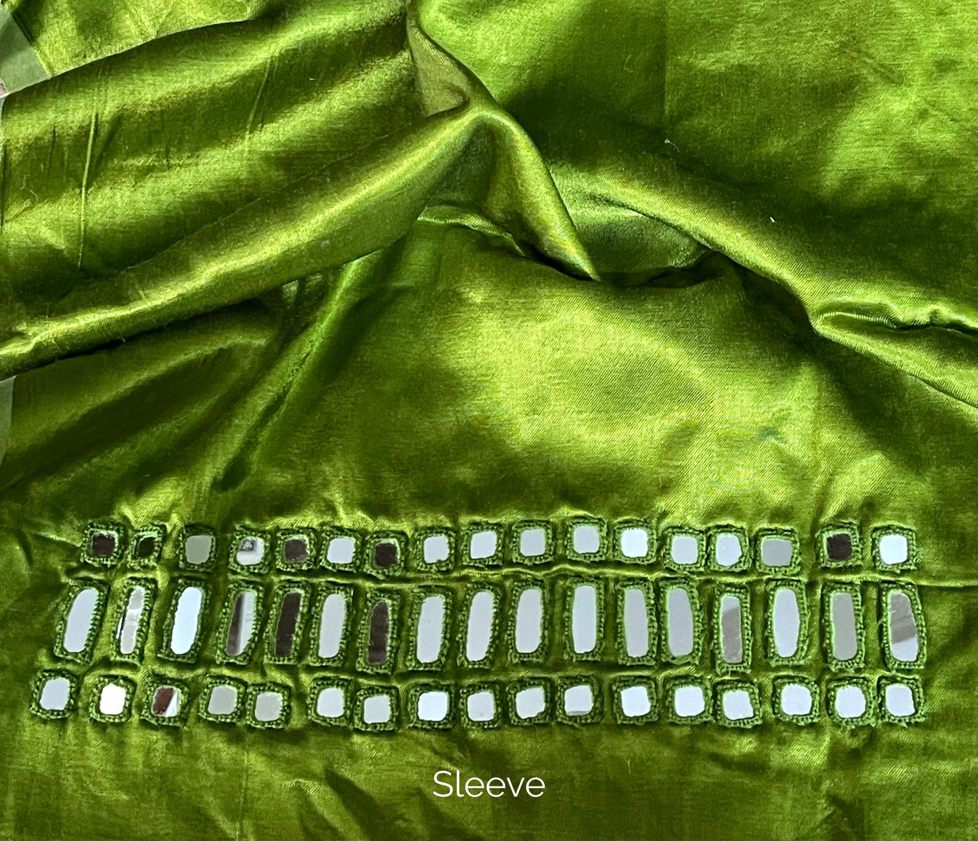 Premium apple green blouse piece adorned with decorative mirror accents