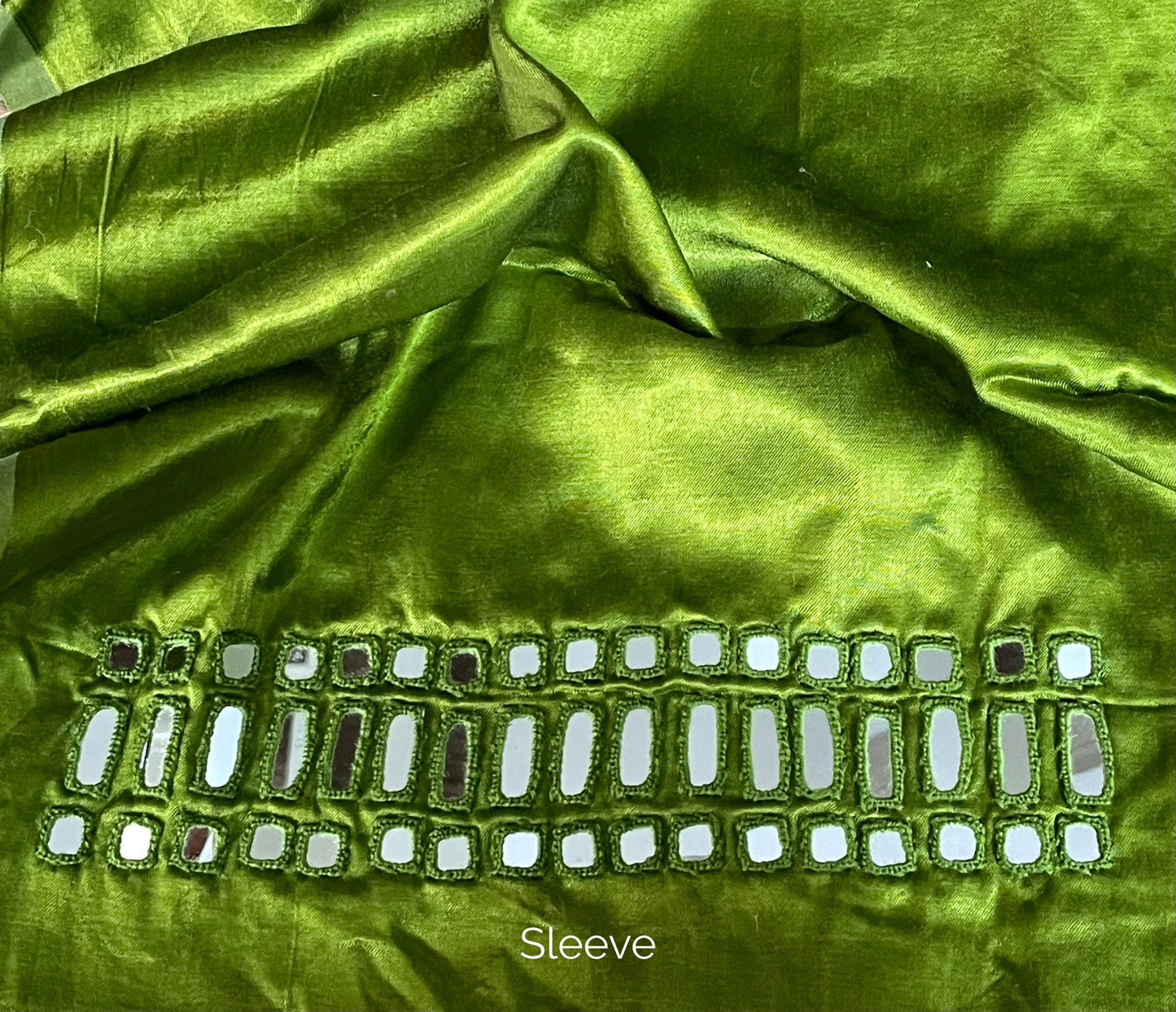 Premium apple green blouse piece adorned with decorative mirror accents