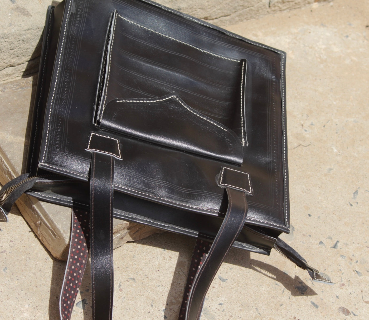 Black handstitched leather bag crafted from premium leather with meticulous handmade detailing