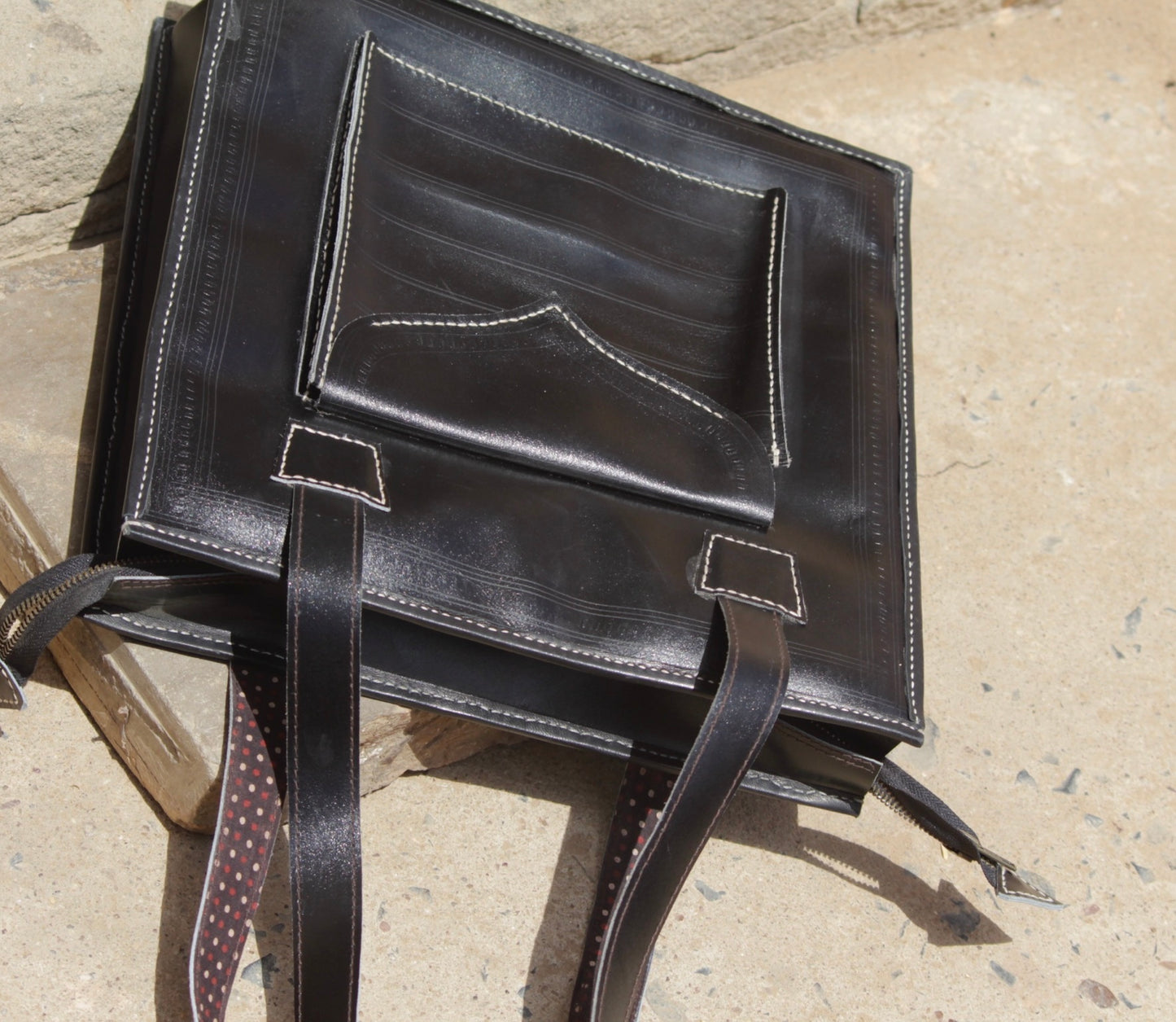 Black handstitched leather bag crafted from premium leather with meticulous handmade detailing