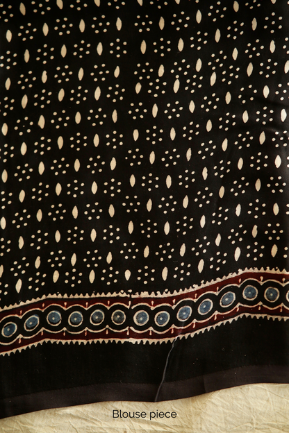 Traditional Black Lotus Ajrakh printed modal silk saree crafted by artisans with fluid texture and timeless appeal