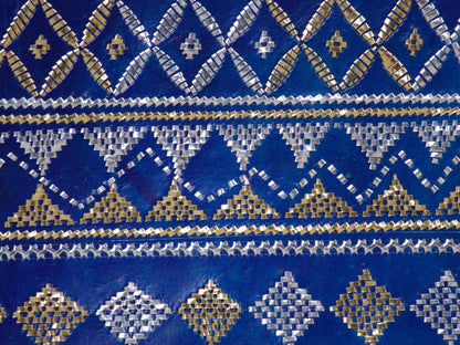 Elegant blue leather bag with shimmering zari accents and timeless appeal