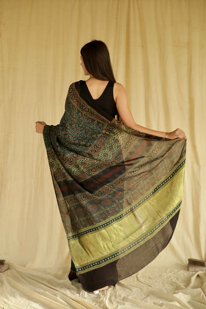 Traditional bottle green Ajrakh printed modal silk saree crafted by skilled artisans with refined detailing
