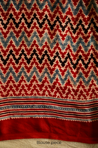 Traditional cherry red Ajrakh printed modal silk saree crafted by artisans with exceptional craftsmanship