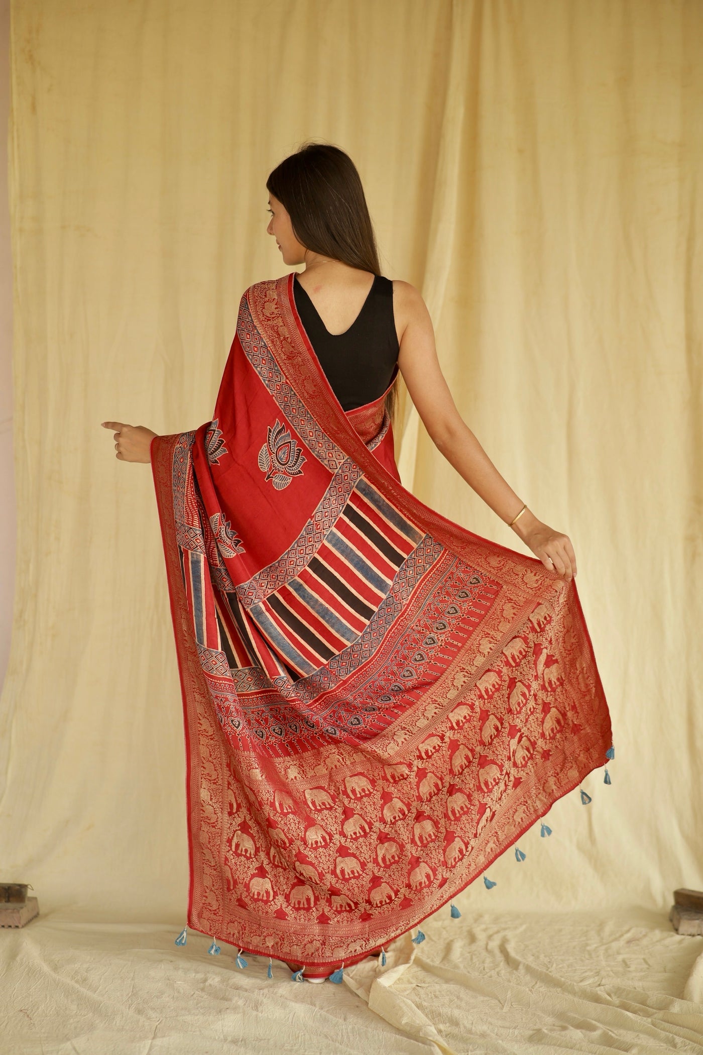 Traditional crimson red Ajrakh printed Dola silk saree with rich craftsmanship and refined detailing