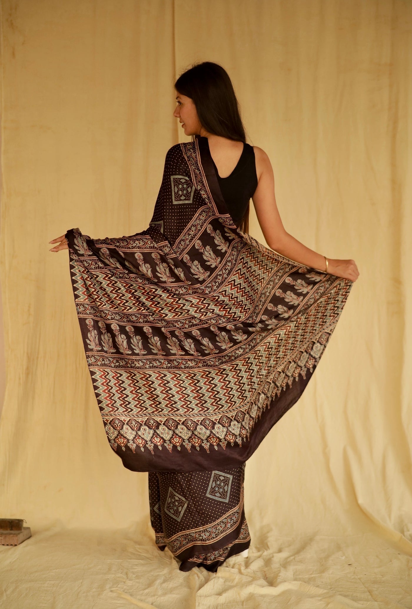 Premium deep black modal silk saree showcasing authentic Ajrakh craftsmanship and heritage-inspired motifs