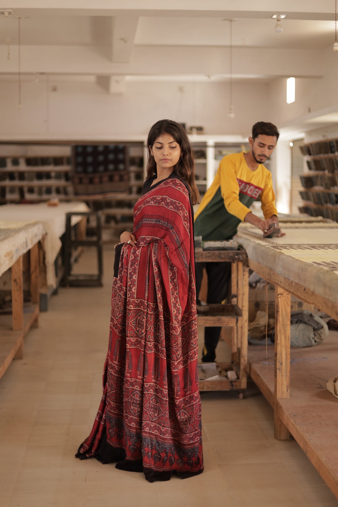 Traditional deep garnet Ajrakh modal silk saree with rich artisanal prints and a soft flowing texture